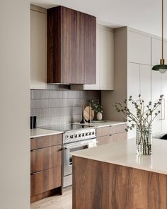 a kitchen with wooden cabinets and white counter tops