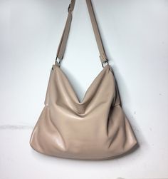 Soft leather purse is elegant and refined. Beige leather tote has comfortable shape, soft and sinuous lines, for special occasions or for everyday. Slouchy hobo bag is made of beige/nude genuine Italian leather of high quality and very soft to the touch. The style of this Slouchy leather bag will give a beautiful accent to your outfit. Materials: - Italian genuine leather - two zipper - one buckle - resistant polyester 100% wire Measurements: Medium bag - length 14,17 inches (36 cm)  - height 12 Leather Bags Women, Slouchy Hobo Bag, Soft Leather Purse, Beige Handbags, White Crossbody Bag, Leather Hobo Handbags, Soft Leather Bag, Italian Leather Bags, Handbags Leather