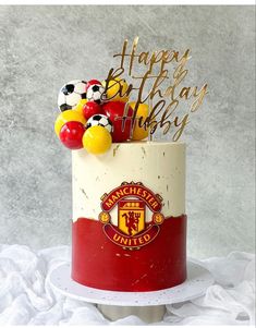 a birthday cake decorated with soccer balls and balloons