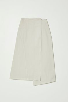 A lean, modern silhouette, skims the body in our soft yet structured drapey cotton twill. A sharp update on the long line denim skirt with a clean false wrap look and asymmetrical detailing. Wear back to your preferred Atelier Delphine knits, add definition to your cold weather wardrobe and wear through every season. - Asymmetrical detail at waist and hem- Side zip closure- Curved stitch detail along right body- Longer midi length Fabric Notes 100% Cotton Machine Wash Cold Made in USA Model in W Twill Skirt, Long Midi, Jumpsuit Jacket, Skirt Socks, Asymmetrical Skirt, Tee Dress, Sweater Blouse, Skirt Pants, Cotton Twill