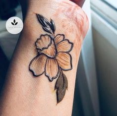 a woman's arm with a flower tattoo on it, and the wrist is shown