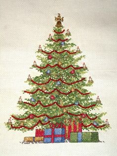 a cross stitch christmas tree with presents under it