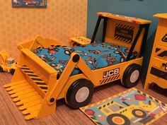 a yellow construction truck bed in a child's bedroom