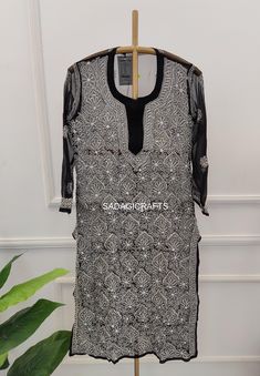 DESCRIPTION ▪ Fabric: Georgette ▪ Sleeves: 3/4 Sleeves ▪ Style: Straight Kurti ▪ Length: 44-46 Inches ▪ Occasions: Casual Wear, Office Wear, Festive Wear ▪ Garment Care: Hand Wash Only ▪ Net Content: 1x Kurti with inner Black Traditional Wear With Long Sleeves And Patterns, Traditional Festive Kurta With 3/4 Sleeves, Festive Traditional Kurta With 3/4 Sleeve, Traditional Embroidered Sets With 3/4 Sleeve, Black Bohemian Kurta With Intricate Embroidery, Traditional 3/4 Sleeve Kurta For Diwali, Bohemian Kurta With Self Design For Transitional Season, Bohemian Kurta With Self Design, Traditional Kurta With 3/4 Sleeve For Eid