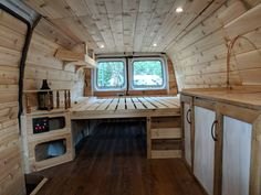 the interior of a tiny cabin with wood walls