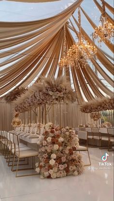 an elegant wedding setup with flowers and chandeliers