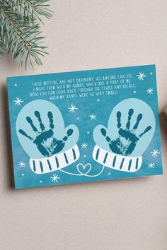 a christmas card with two hand prints on it