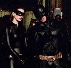 two women dressed as batman and catwoman standing next to each other