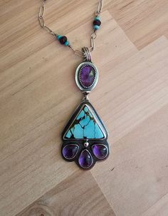 "Turquoise and amethyst.  This is constructed from 925 sterling silver.  I have chosen a beautiful genuine triangle shape turquoise for this statement piece. The color in this stone is phenomenal.  I  paired the turquoise with beautiful amethyst.  The top amethyst is a faceted stone.  And the teardrops are a fantastic smooth finish.  And to make this piece personal,  I have created the chain.  Incorporating tiny pilot Mountain turquoise rondels on each side of faceted amythest beads.  This is a gorgeous statement.  Worn for years to come.  20\" length  See pictures for size reference.  Ready to ship." Pilot Mountain, Amethyst Necklace, Triangle Shape, Silver Turquoise, Turquoise Sterling Silver, Lebanon, Jewelry Necklace Pendant, Amethyst, Jewelry Necklaces