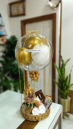 a glass display case with gold and white ornaments