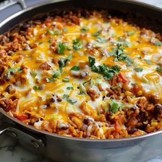 a casserole dish with meat, rice and vegetables