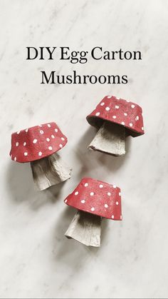 three red and white polka dot covered mushrooms on a marble counter top with one mushroom sticking out of it's shell