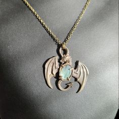 a necklace with a dragon pendant on it