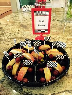 a plate filled with fruit on top of a counter next to a sign that says fault