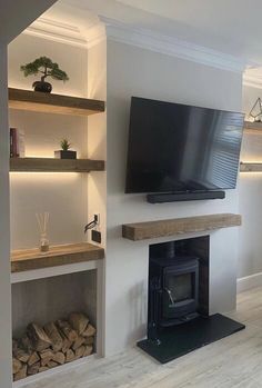 a flat screen tv mounted to the side of a wall next to a fire place