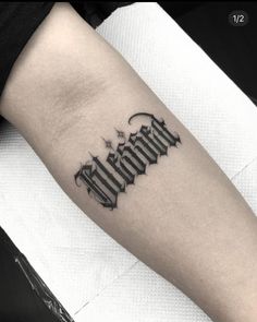 a black and white photo of a tattoo on the arm