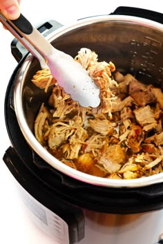 someone is stirring some food in the slow cooker