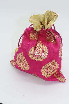 a small pink bag with gold designs on it