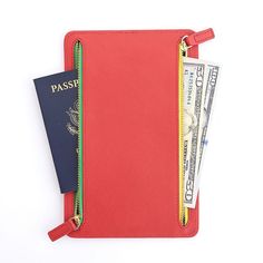 a red passport case with two credit cards in it and an american flag sticking out of the front pocket