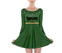 a woman wearing a green dress with gold trim