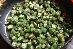 a pan filled with green peppers on top of a table