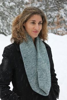 a woman standing in the snow with her hands on her hips