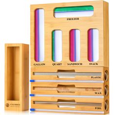 an assortment of different colored pencils in a wooden box next to a sharpener