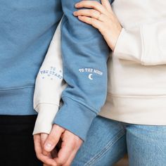 "This lovely, embroidered sweatshirt set from Rock On Ruby is perfect for cosying up in on your date night... This matching set includes 2 unisex sweatshirts: 1 x Dusky Blue Sweatshirt with cream embroidery on the cuff which reads: To The Moon 1 x Cream Sweatshirt with Marine Blue embroidery on the cuff which reads: To The Stars Each sweatshirt features little illustrated designs (Moon or Stars) along with the embroidered slogan These tops are unisex in style and have a relaxed fit FAIRWEAR SWEA Matching Hoodies For Couples, Clothes Embroidery Diy, The Moon And Stars, Matching Hoodies, Embroidery Hoodie, Couples Sweatshirts, Matching Sweatshirts, Embroidery On Clothes, 자수 디자인