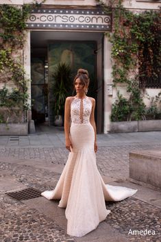 a woman in a wedding dress standing on the street