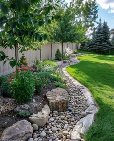 a garden with rocks, grass and trees in the back yard is very nice to have