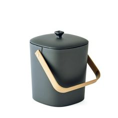 a black container with a wooden handle on the top and bottom, sitting in front of a white background