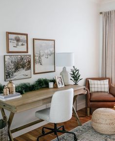 a home office with two chairs, a desk and pictures on the wall