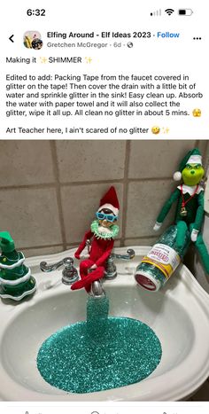 an elf is sitting in the bathroom sink with blue glitter on it's rim