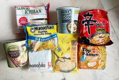 several different types of food are on the floor next to each other, including rice noodles and ramen noodles