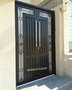 the front door to a house with glass and wrought iron designs on it's sides