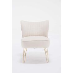 an upholstered white chair with gold legs