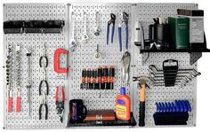 there are many tools hanging on the pegboard