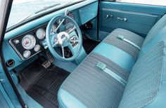 the interior of an old car with blue leather