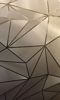 a close up view of a metal surface with lines and dots on it, as well as an abstract design