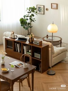 a living room filled with furniture and a lamp on top of a wooden table in front of a window