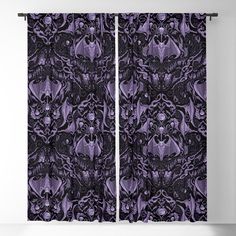 a purple and black curtain with an intricate design