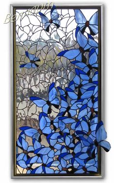 a stained glass window with blue butterflies on it