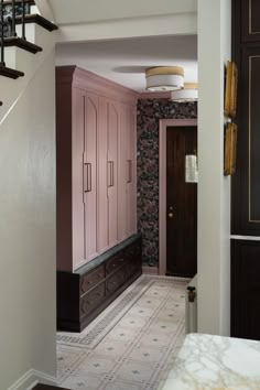 the hallway is decorated in pink and black with floral wallpapers on the walls