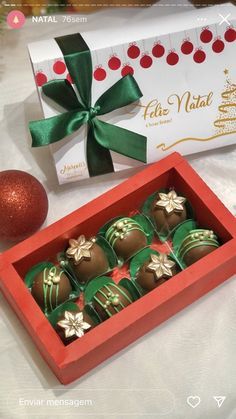 a box of chocolates sitting on top of a table next to a christmas ornament