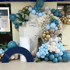 balloons and decorations are arranged on the floor in front of a sign that reads cauver