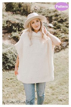 a woman wearing a white ponchy with a hat on her head standing in the grass