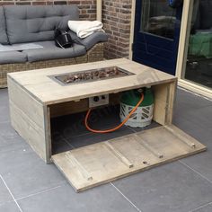 a coffee table made out of pallet wood with a fire pit in the middle