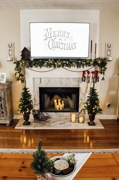 a fireplace decorated for christmas with lit candles