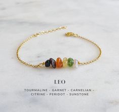 "This raw crystal bracelet represents Leo zodiac sign and is designed with natural gemstones specifically for Leo. It is made of the following raw crystals: Tourmaline, Garnet, Carnelian, Citrine, Peridot and Sunstone. It compliments and enhances Leo peace, harmony and well being. It is perfect for layering and will be a meaningful July and August birthday gift for your loved ones :) ● More Zodiac Astrology Sign Jewelry: https://etsy.me/3CByaSC ● BRACELET LENGTH: adjustable 6.5\"-8\" / 16.5-20cm Leo Crystals, Unique Beaded Bracelet, Leo Zodiac Sign, Zodiac Sign Astrology, Astrology Jewelry, August Birthday, Raw Crystals, Zodiac Signs Astrology, Zodiac Astrology