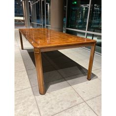 a wooden table sitting on top of a tiled floor